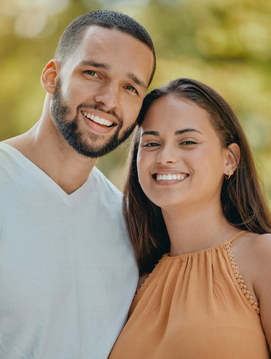 Portrait, happy and couple in nature to relax on a honeymoon vacation, holiday or weekend in Brazil, Sao Paulo. Smile, partners and healthy woman enjoying quality time, bonding and marriage with man